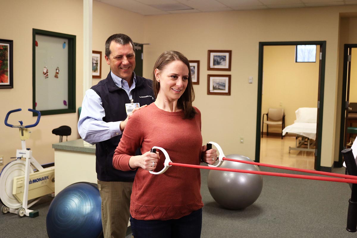 Physical Therapist with Patient using stretching bands